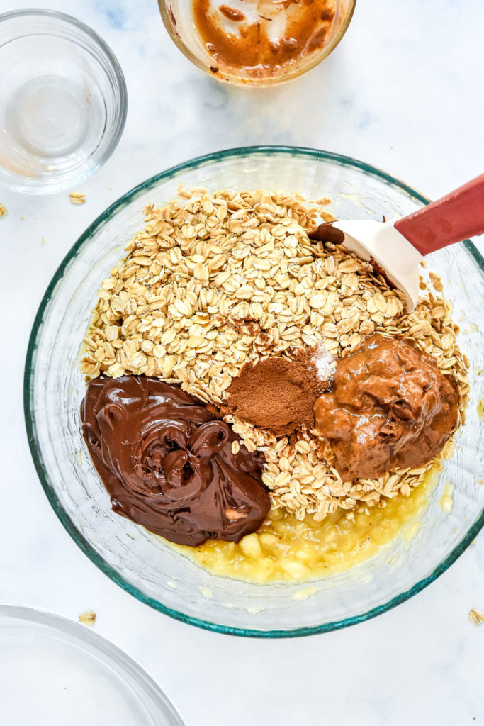 ingredients in a bowl before mixing up the banana chocolate oatmeal mounds.