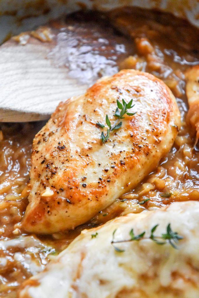 golden brown chicken breast with a sprig of thyme on top.