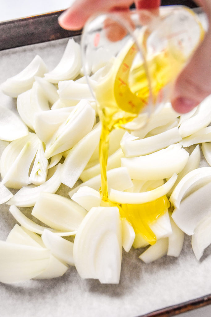 pouring olive oil on cut onions.