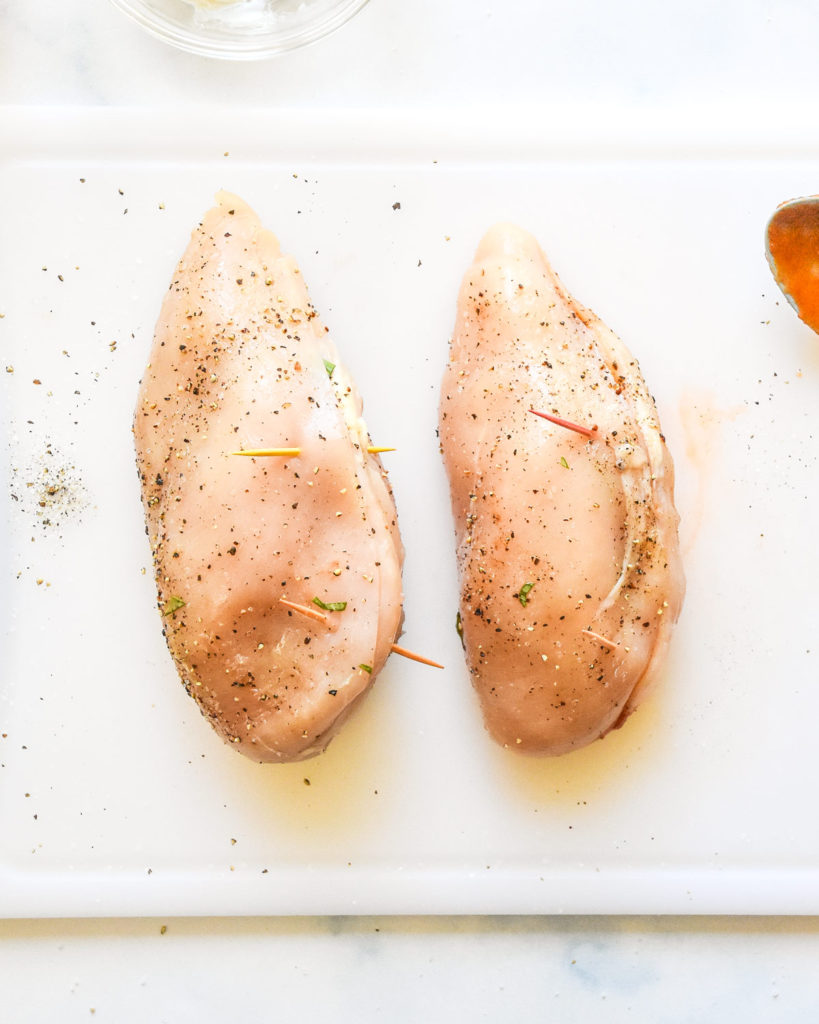 stuffed chicken breasts with toothpicks holding them closed.