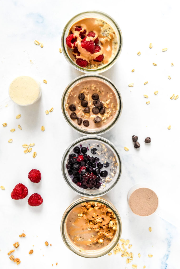 overnight oats with various toppings in glass mason jars.