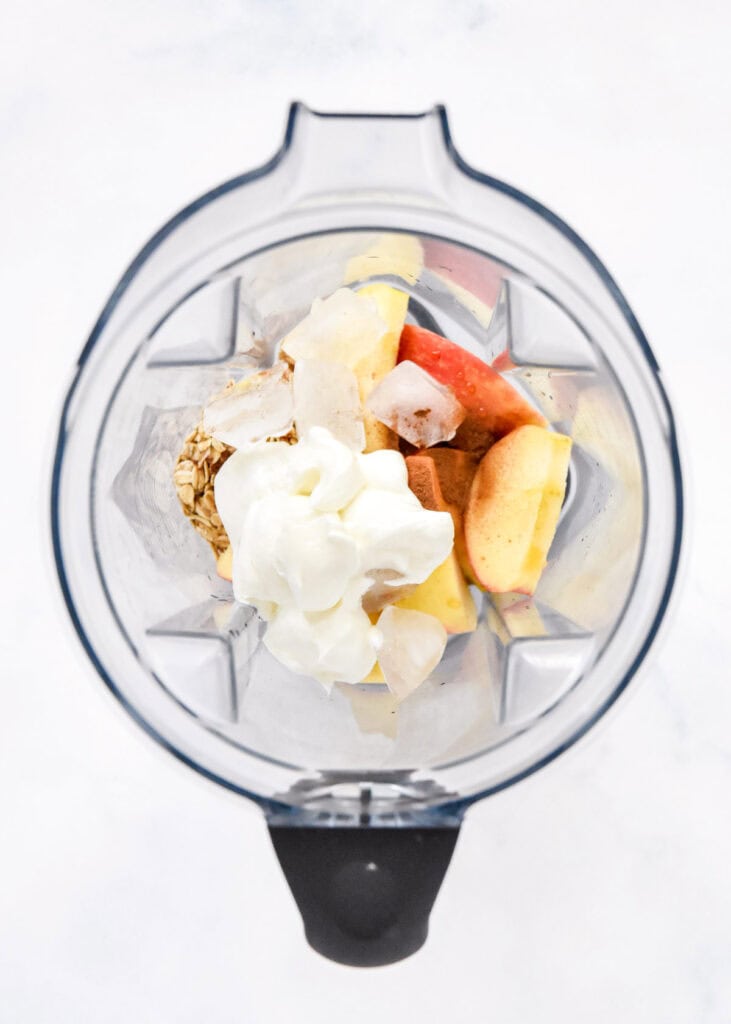 ingredients in the blender before blending up the cozy apple pie smoothie.