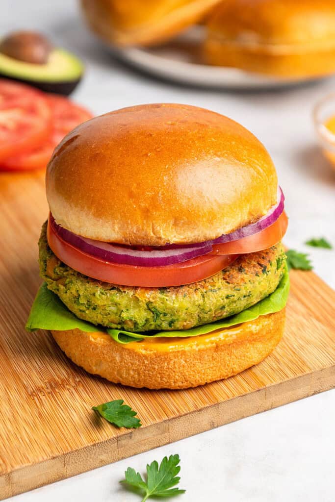 herby chickpea veggie burgers with a brioche bun and toppings.