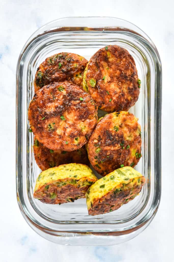 spring vegetable mini crustless quiches in a glass meal prep container.