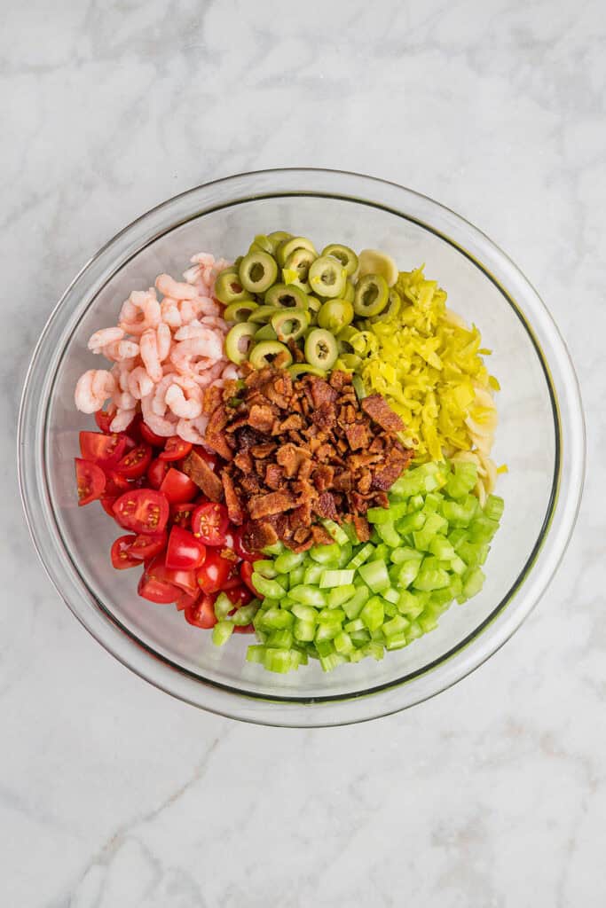 ingredients required for the loaded bloody mary pasta salad before mixing in the vinaigrette sauce.