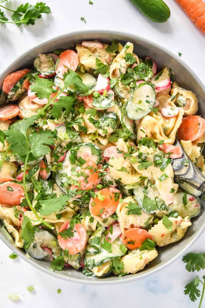prepared banh mi inspired tortellini salad in a glass mixing bowl.