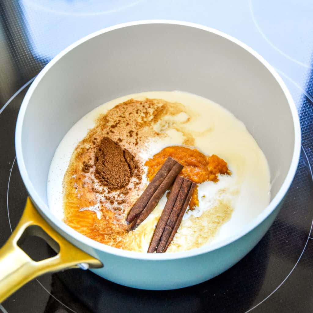 cream, milk and spices in a pot to make the homemade pumpkin spice coffee creamer.