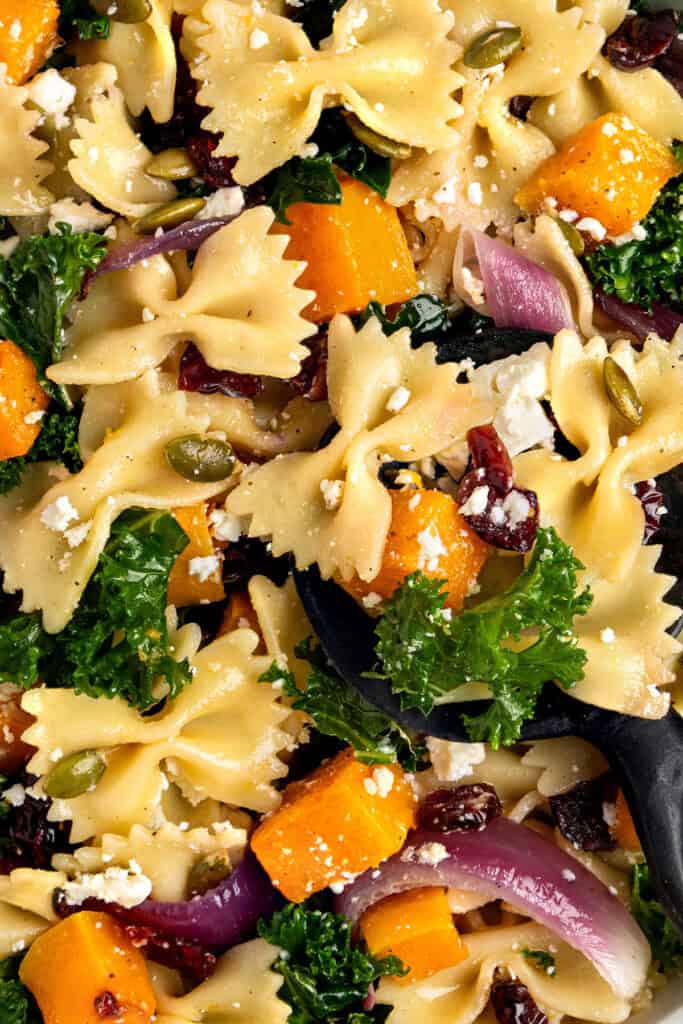 close up of the fall pasta salad with maple vinaigrette with extra feta cheese on top.